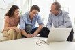 Couple signing papers with financial advisor