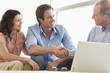 Couple shaking hands with financial advisor