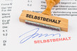 Holzstempel auf Dokument: Selbstbehalt
