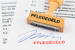 Holzstempel auf Dokument: Pflegegeld