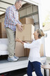 Husband handing wife box from moving van
