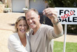 Proud couple holding keys to new home