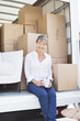 Woman drinking coffee on back of moving van