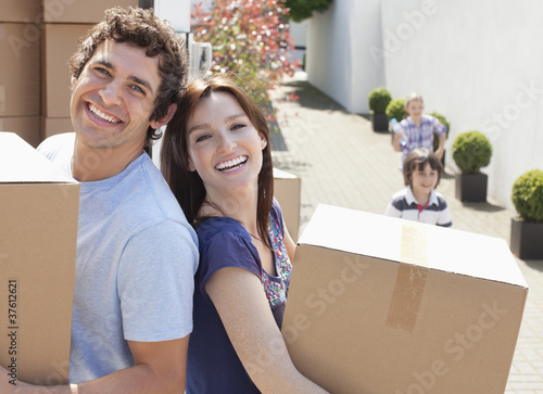 Photo: Couple unloading boxes from moving van Couple unloading boxes from moving van