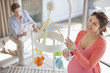 Expectant mother looking at crib mobile
