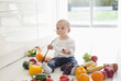 Baby making mess on floor with food