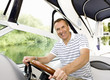 Man driving boat on river