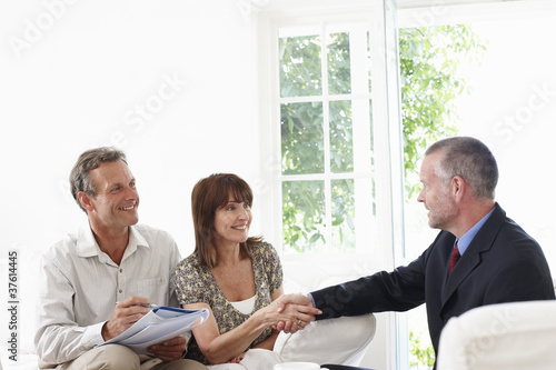 Photo: Couple shaking hands with financial advisor Couple shaking hands with financial advisor