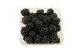 box of fresh blackberries on a white background