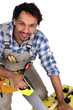 Image : Tradesman sawing a piece of wood