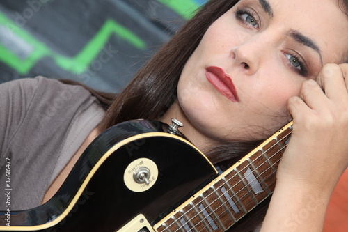 Photo: Brunette with electric guitar Brunette with electric guitar