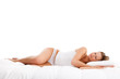 Woman lying on bed isolated on white background
