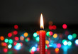red candle on dark background