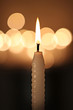 white candle on dark background