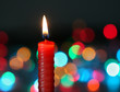 red candle on dark background