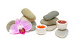 Spa concept - orchid candles and sea pebbles.