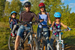 Family cycling. Happy parents with kids on bikes