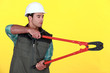 Tradesman holding large clippers