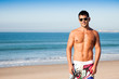 Handsome young muscular man at the beach