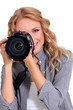 Woman using photo camera in studio Woman using photo camera in studio
