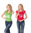 Foto: Blond women with colored shirt having opposite opinion Blond women with colored shirt having opposite opinion