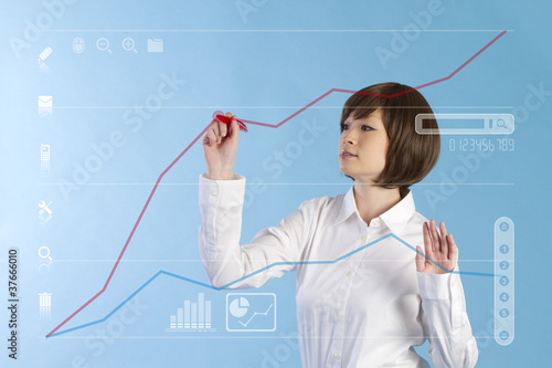 Photo: Beautiful business woman tocuhing on blue background Beautiful business woman tocuhing on blue background
