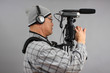 Man with HD SLR camera and audio equipment
