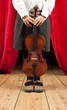 Little girl with violin on stage theater