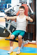 positive man at chest pectoral exercises machine