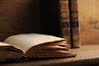 Photo: old book open on a wooden table old book open on a wooden table
