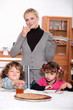mother holding and children waiting to eat crepes