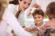 Teacher helping children in class
