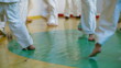 Children practice karate in gym