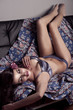 girl posing in lingerie on a sofa