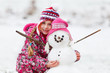 Foto: girl with her snowman winter fun girl with her snowman winter fun