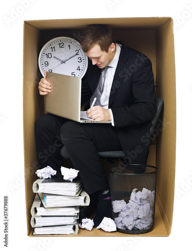 Photo: Businessman in a tight office Businessman in a tight office