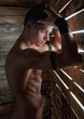Foto: Muscle sexy naked young man near to wooden boards Muscle sexy naked young man near to wooden boards