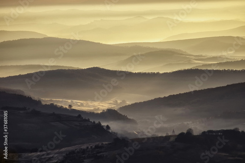 Photo: valley in a beautiful early morning with fog and hills valley in a beautiful early morning with fog and hills
