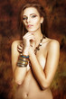 Sexy nude woman on gold background