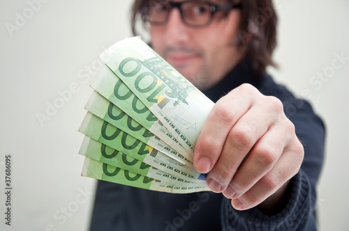 Photo: Man paying in euros Man paying in euros
