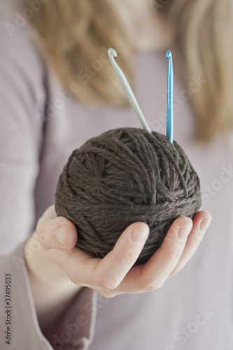 Photo: Ball of yarn and crochet needles Ball of yarn and crochet needles