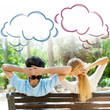 Smiling beautiful couple sitting on a banch at summer park and d