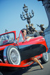 Happy smiling woman in a car. Romantic in Paris.