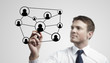 Young business man drawing a social network