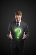 Businessman with a question mark on his hands Businessman with a question mark on his hands