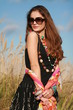 Young woman wearing jewellery and sunglasses Young woman wearing jewellery and sunglasses