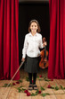 Little girl playing violin on stage theater