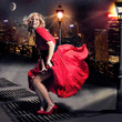 Red dressed Marilyn Monroe double with flying skirt in the city