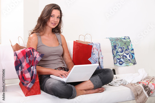 Photo: Woman surrounded by shopping bags Woman surrounded by shopping bags