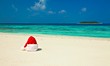 Santa hat is on a beach